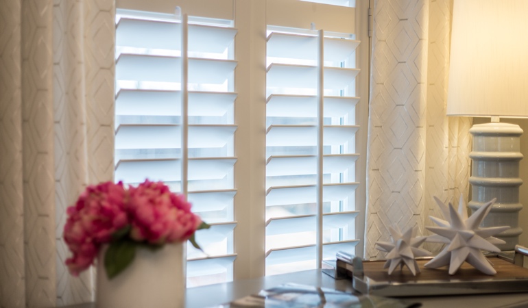 Plantation shutters by flowers in Austin